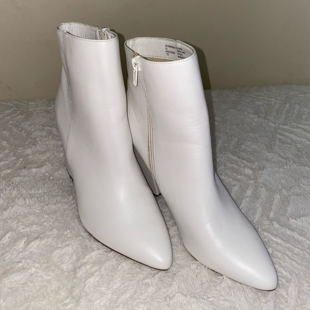 White, pointed toe booties.